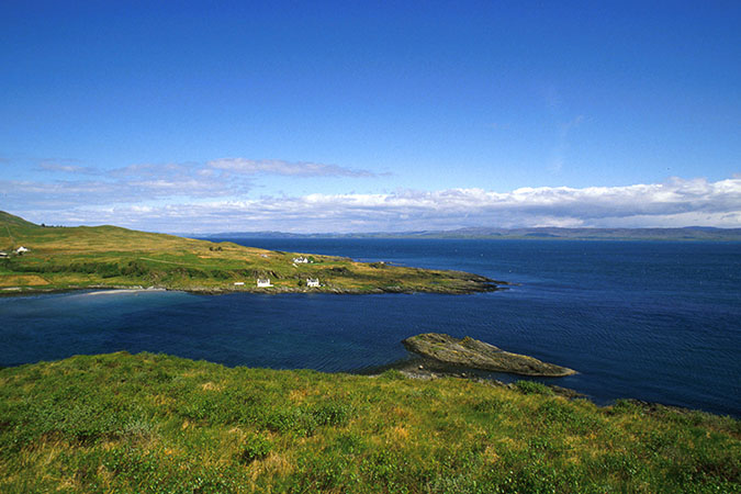 LOOKING ACROSS TO COTTAGES ON A PENINSULA ALONG THE COASTLINE OF THE ISLE OF JURA, INNER HEBRIDES