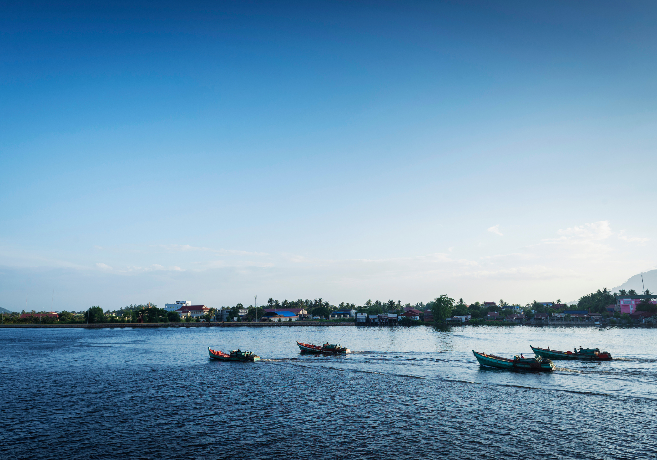 traditional fishing boats on kampot river in cambodia