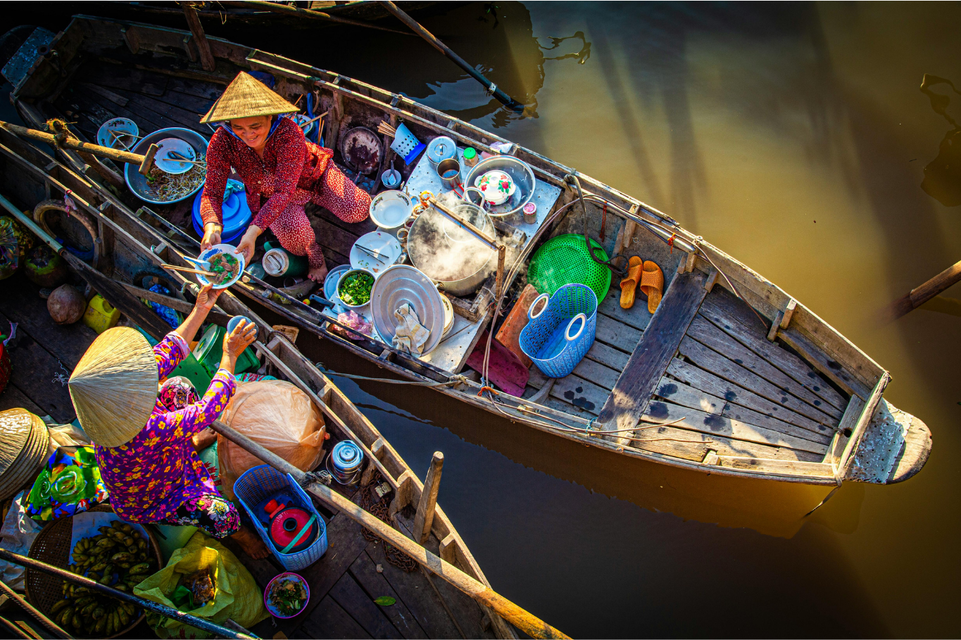 Local vendors trading from boats at Cai Rang Floating Market, a popular experience for families with teenagers.