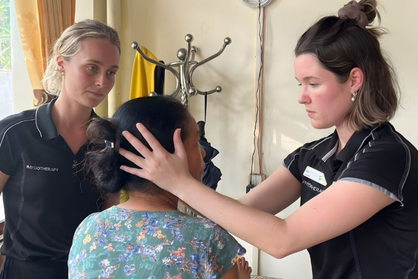 Healthcare students providing basic health check-ups for elderly residents during an educational travel program in Mai Chau, Vietnam.