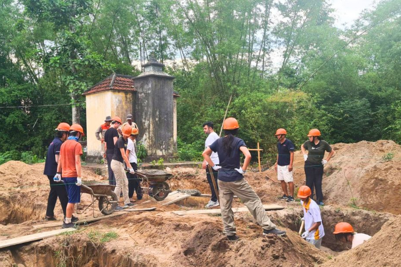 Students participating in educational travel by helping build the foundation of a community library in Ky Anh, Vietnam.