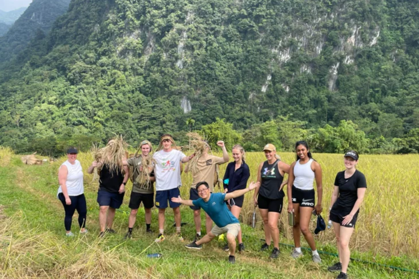 Students participating in educational travel activities in the rice fields of Mai Chau, Vietnam.