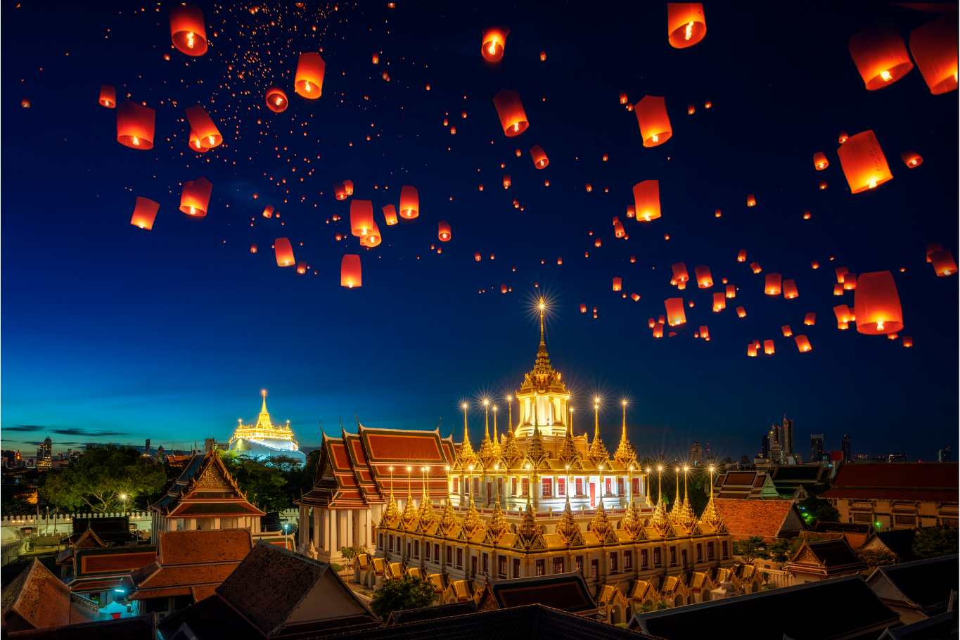 Hundreds of sky lanterns floating above Loha Prasat during Yi Peng.