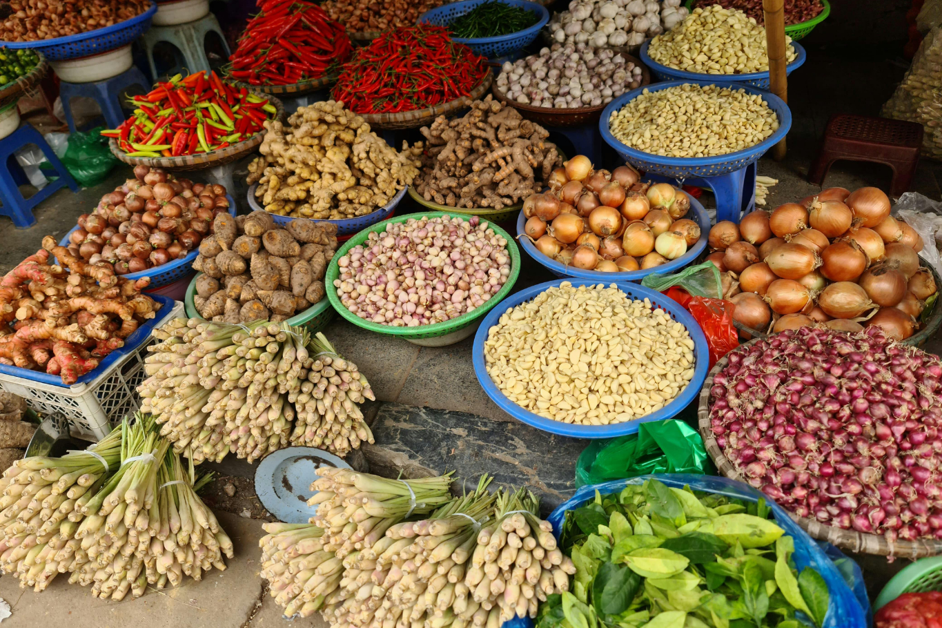 Fresh vegetables, local herbs, and colorful ingredients displayed at a Vietnamese market