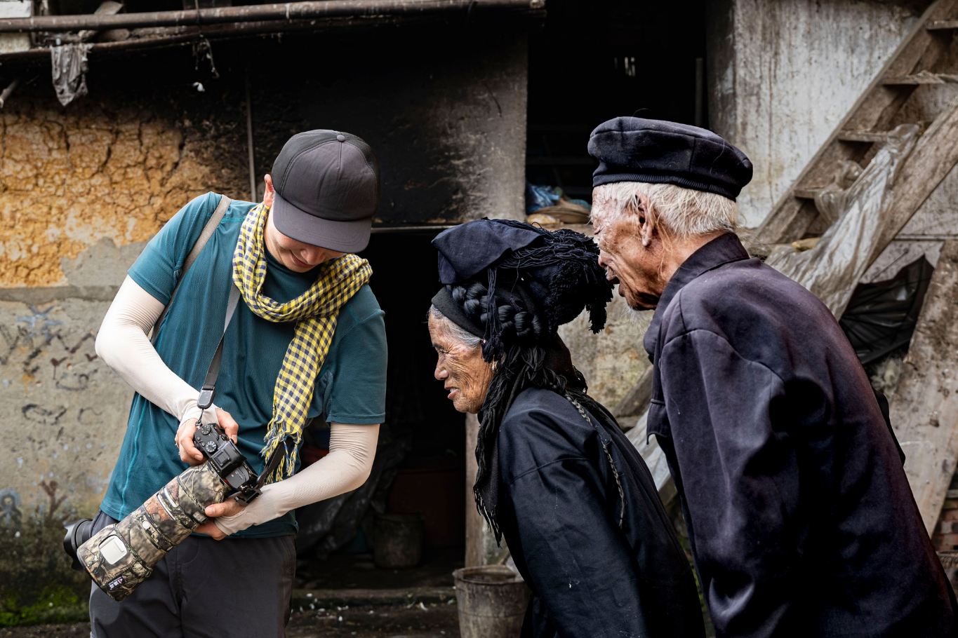 Traveler showing photos to ethnic minority elders in Northern Vietnam