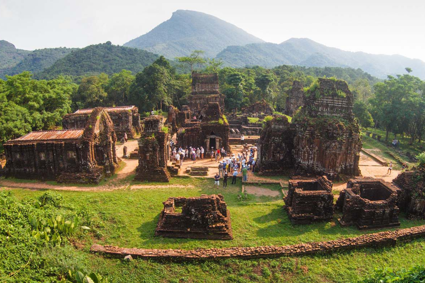 Tourists exploring the ancient brick ruins of My Son Sanctuary