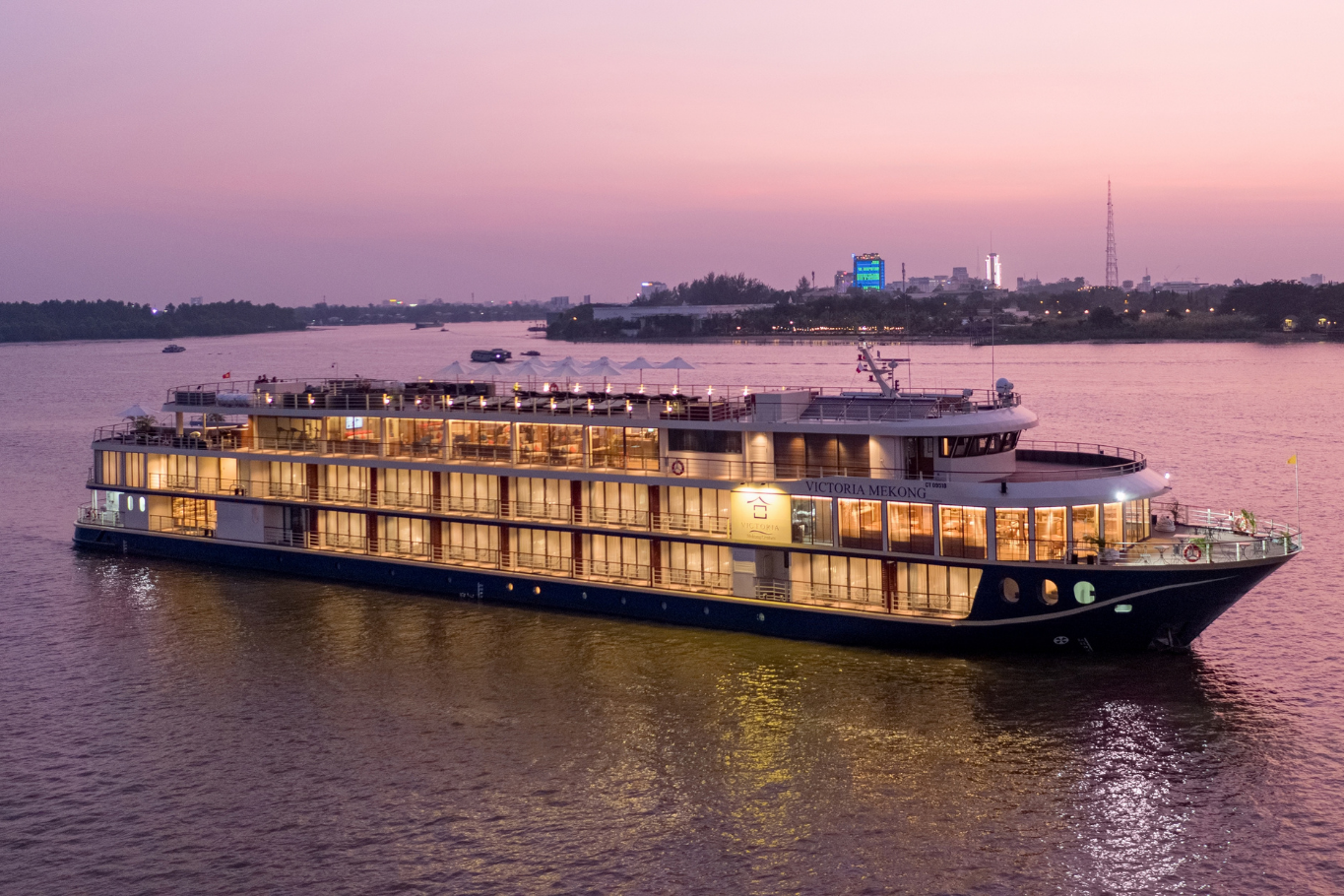 Luxury river cruise sailing at sunset in the Mekong Delta
