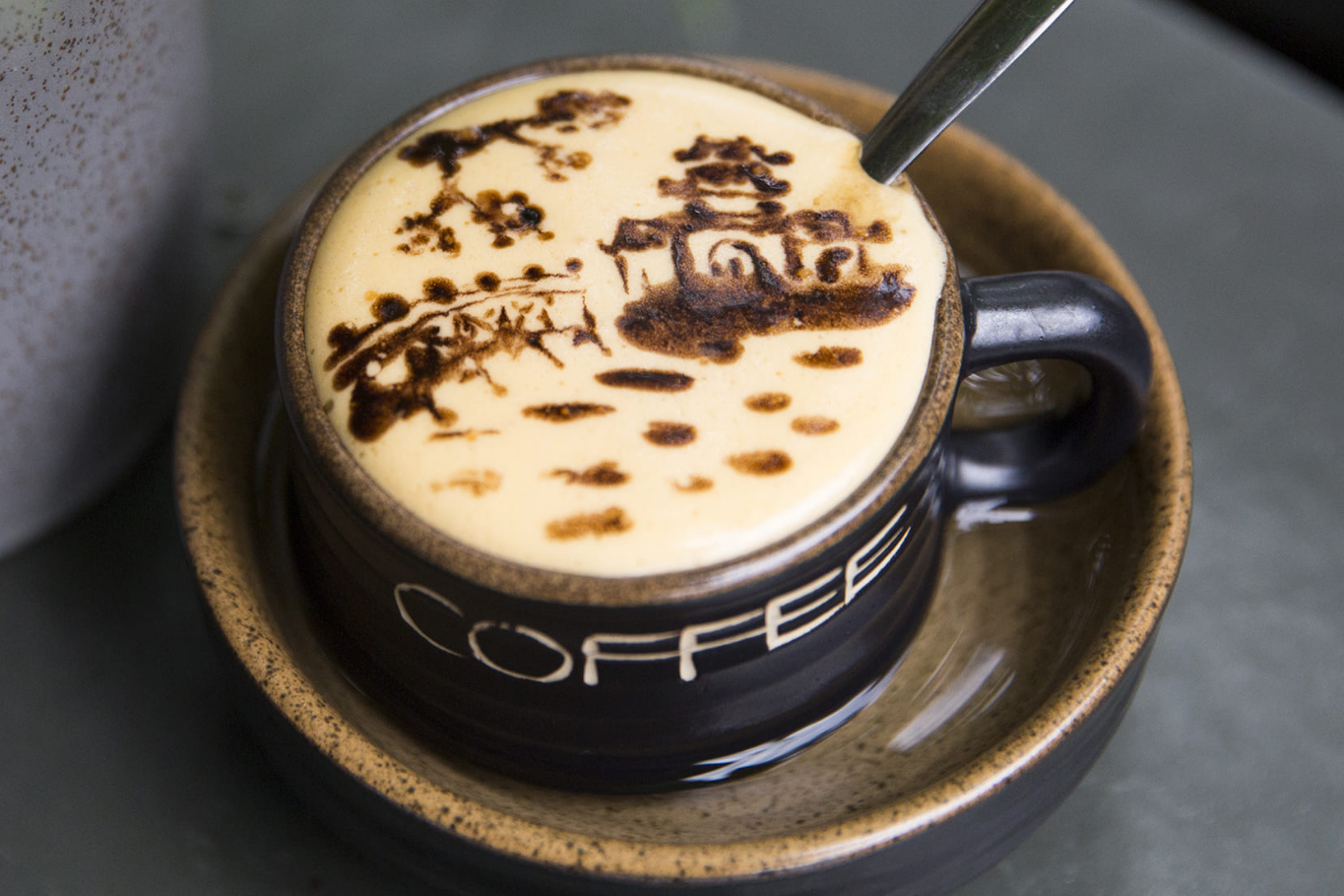 Authentic Vietnamese egg coffee with artistic foam art for first-time travelers
