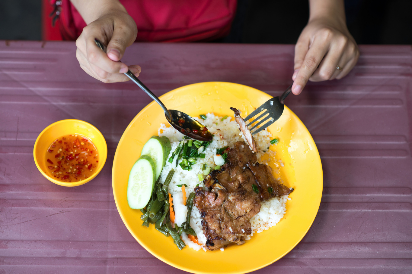 Savory grilled pork broken rice showcases the rich street food culture of Saigon.