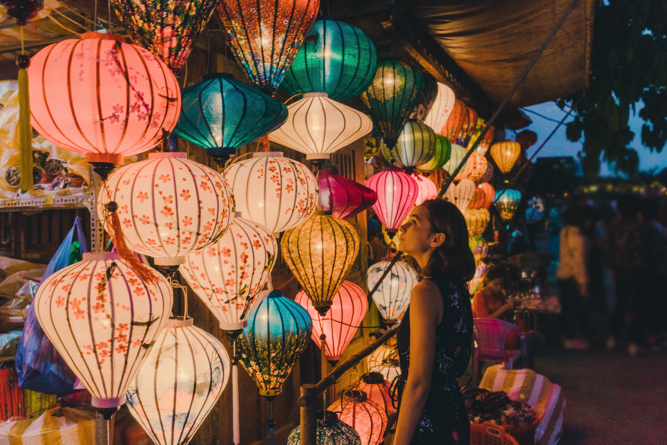 Colorful silk lanterns illuminating historic evening streets of Hoi An ancient town.