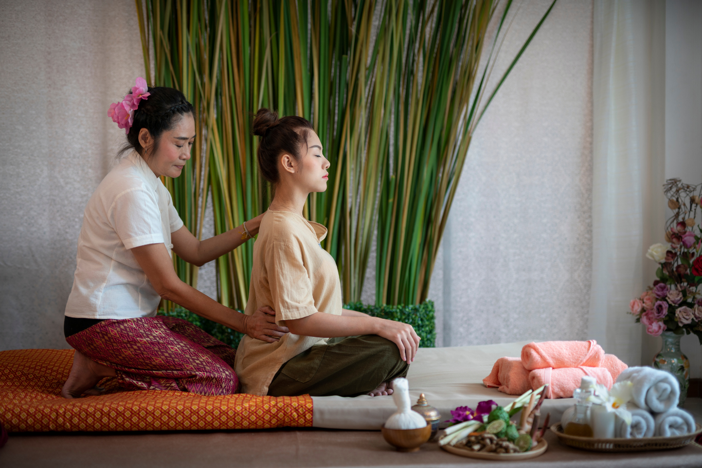 A guest receiving a traditional Thai massage therapy