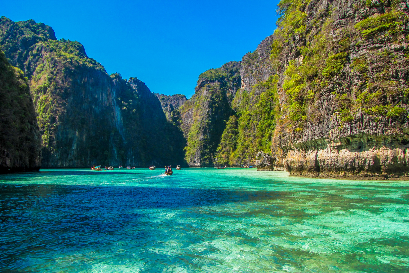 Dramatic limestone cliffs encircling emerald waters in Thailand