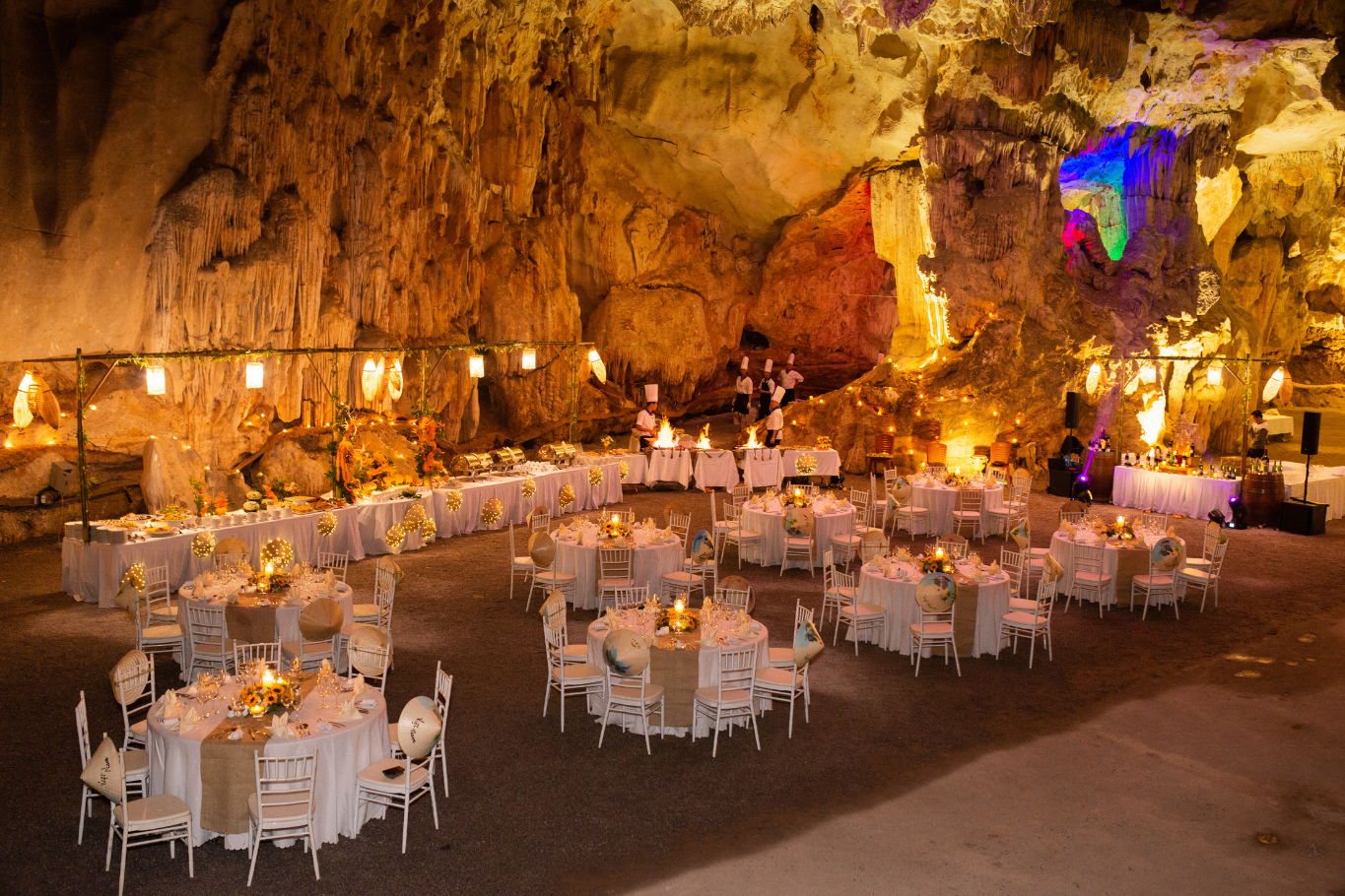 Exclusive private dining banquet set up inside a illuminated cave in Ha Long Bay Vietnam.