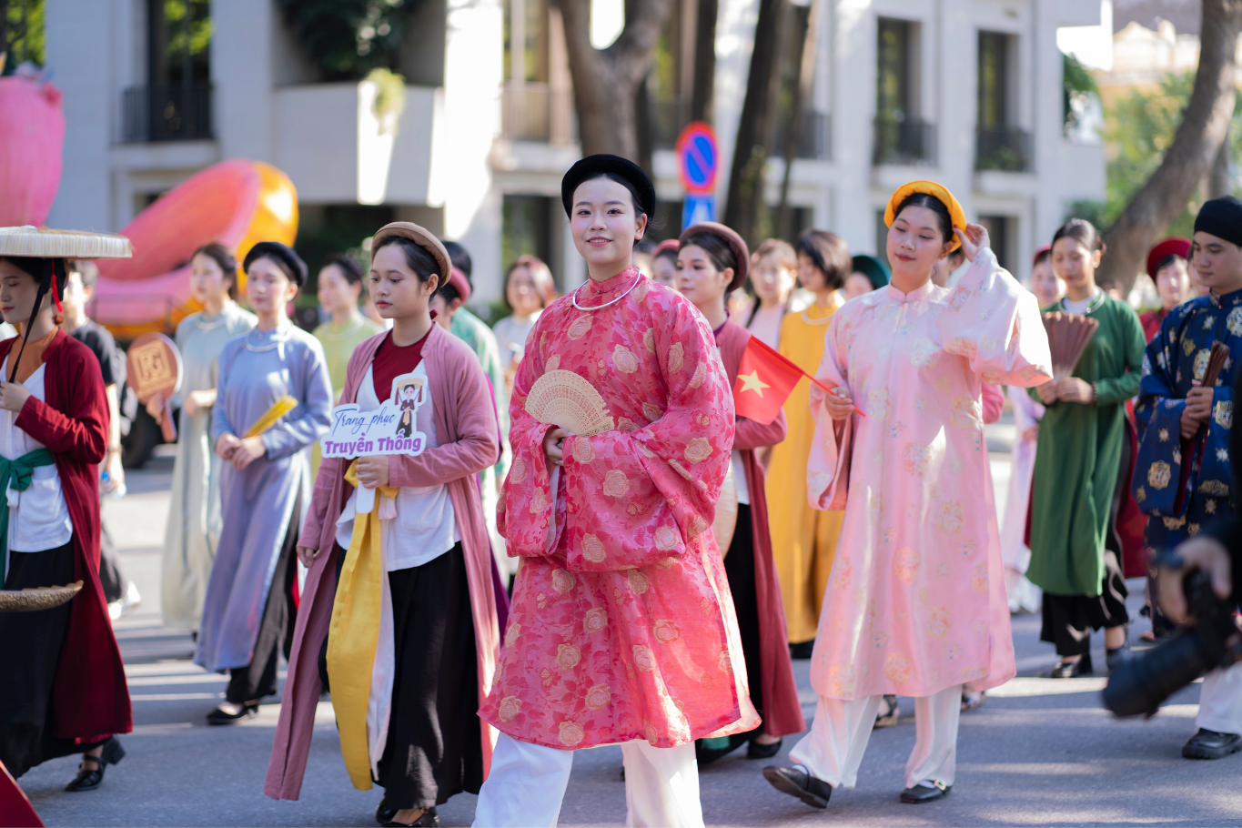 Vietnamese women wearing traditional Ao Dai dresses during a cultural heritage parade