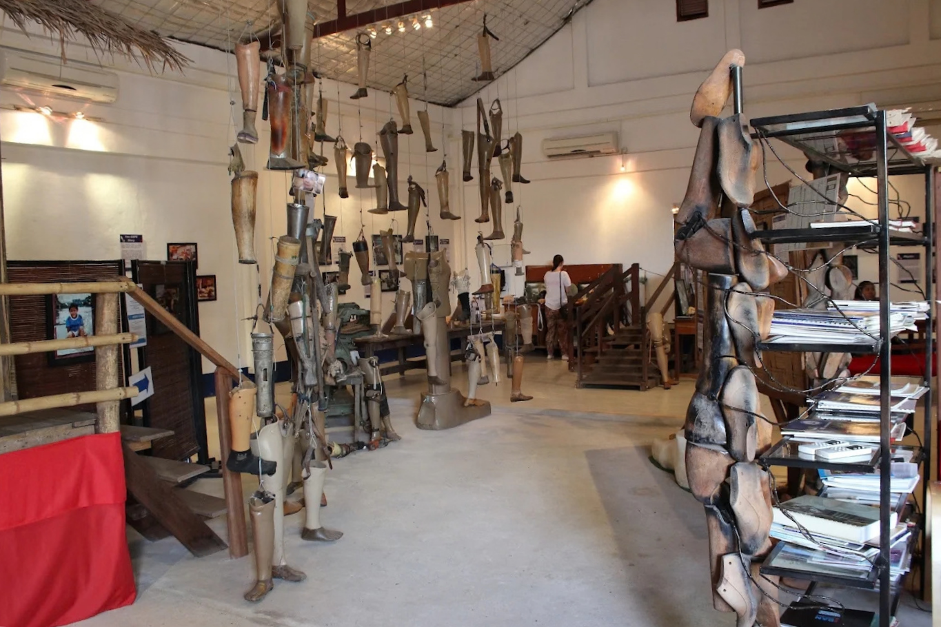 The interior of the COPE Visitor Centre featuring hanging prosthetics and informational displays.